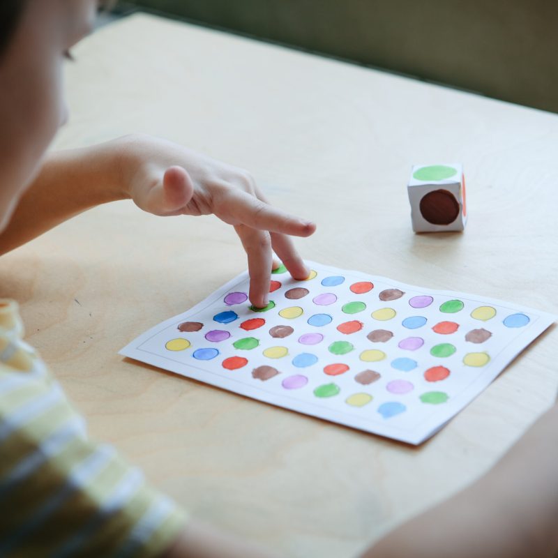 Child playing diy dot game for fingers Child playing diy dot game for fingers. useful game for development of childs fingers